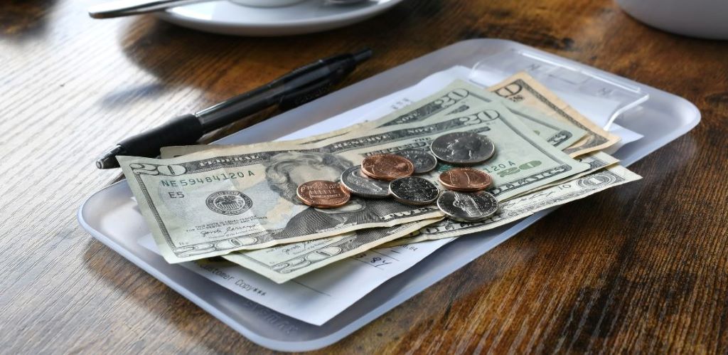 How can I find out the tipping customs of a country I'm visiting?