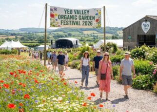 Visitors walking through the six-and-a-half acres of organic-certified Yeo Valley garden in Blagdon, Somerset, surrounded by wildflower meadows and lush borders during the 2026 festival