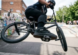 Black aluminum BMX platform pedals mounted on a bike crankset.