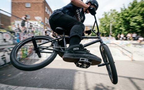 Black aluminum BMX platform pedals mounted on a bike crankset.