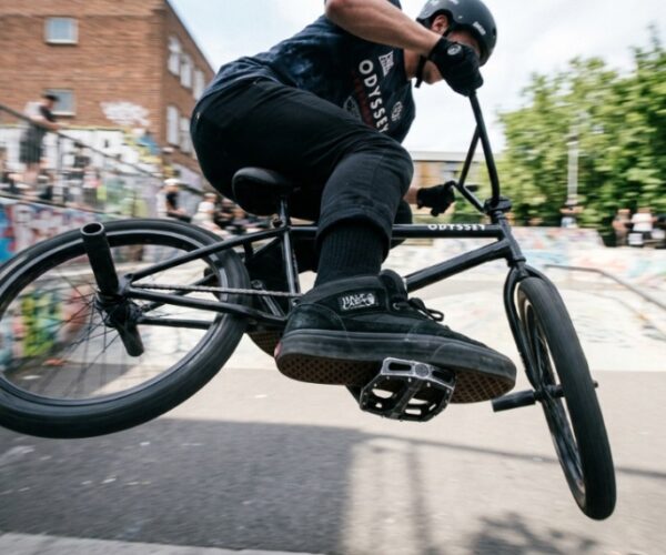 Black aluminum BMX platform pedals mounted on a bike crankset.