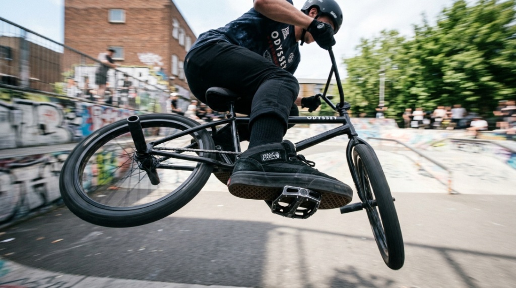 Black aluminum BMX platform pedals mounted on a bike crankset.